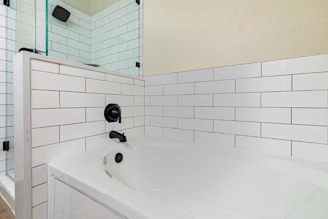 2632 Century Park Boulevard, Unit 18 Austin, TX 78727 - Photo 20 of 32 Full bathroom featuring walk in shower and a garden tub
