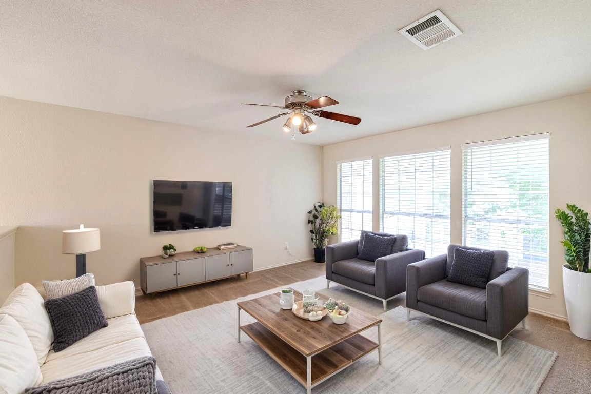 2632 Century Park Boulevard, Unit 18 Austin, TX 78727 - Photo 25 of 32 Living area with ceiling fan and wood finished floors