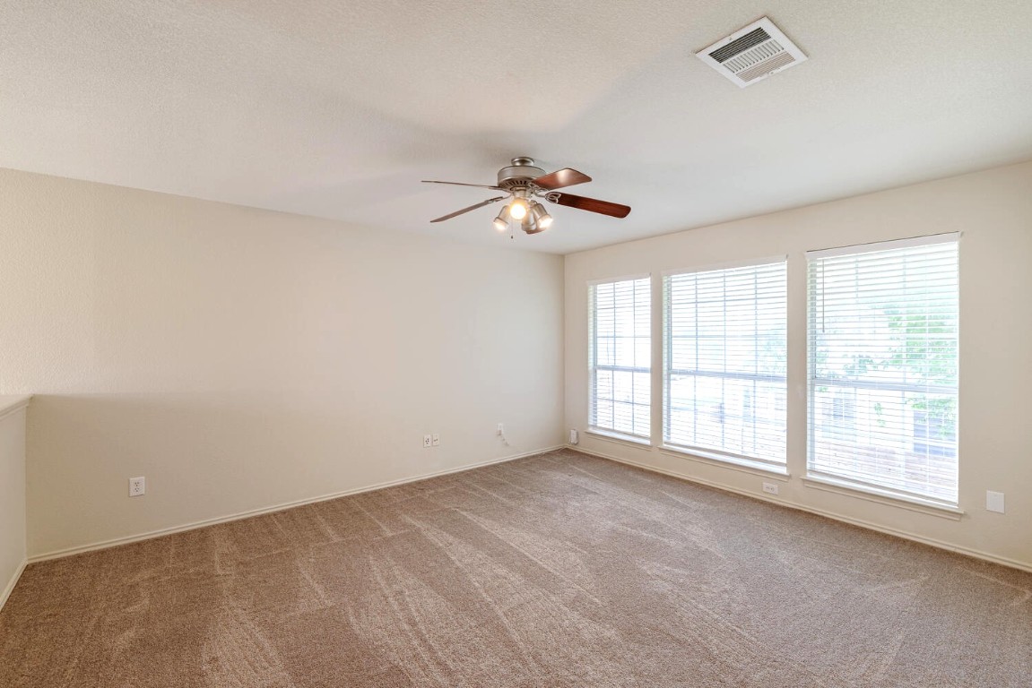 2632 Century Park Boulevard, Unit 18 Austin, TX 78727 - Photo 26 of 32 Carpeted spare room featuring baseboards and a ceiling fan