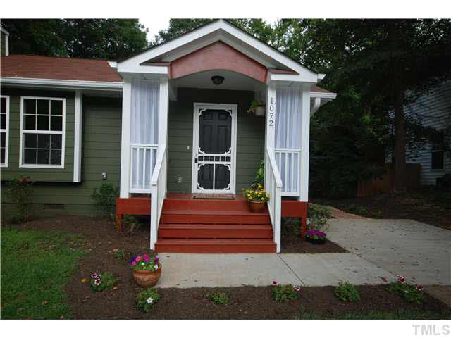 1072 Mills Street Raleigh, NC 27608 - Photo 2 of 25 a front view of a house with a yard