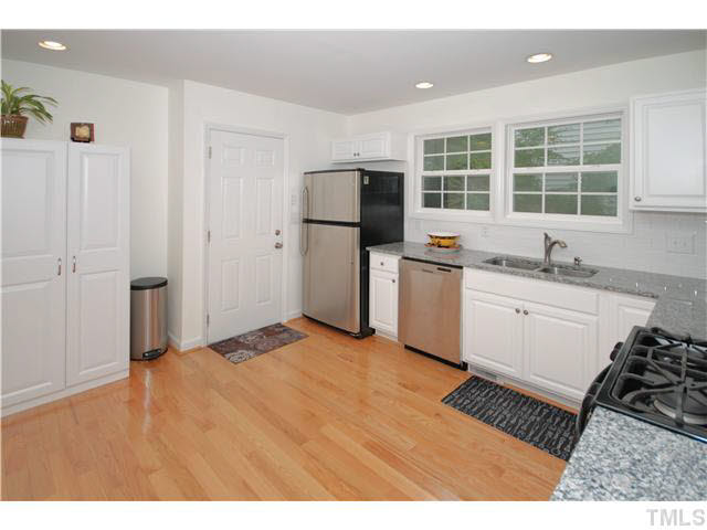 1072 Mills Street Raleigh, NC 27608 - Photo 11 of 25 a kitchen with a sink stove and refrigerator