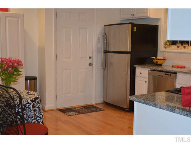 1072 Mills Street Raleigh, NC 27608 - Photo 13 of 25 a kitchen with refrigerator and cabinets
