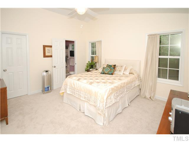 1072 Mills Street Raleigh, NC 27608 - Photo 14 of 25 a bedroom with a large bed and a large window