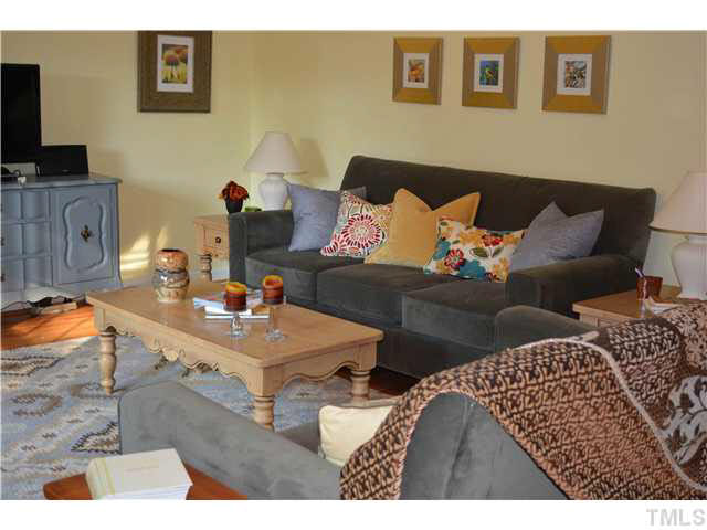 1072 Mills Street Raleigh, NC 27608 - Photo 3 of 25 a living room with furniture and a flat screen tv