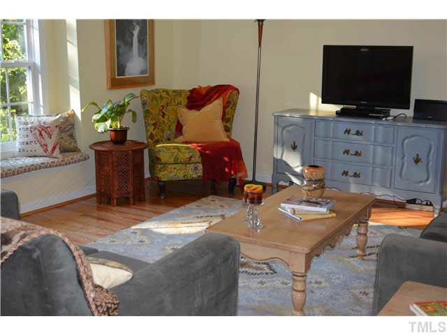 1072 Mills Street Raleigh, NC 27608 - Photo 4 of 25 a living room with furniture and a flat screen tv