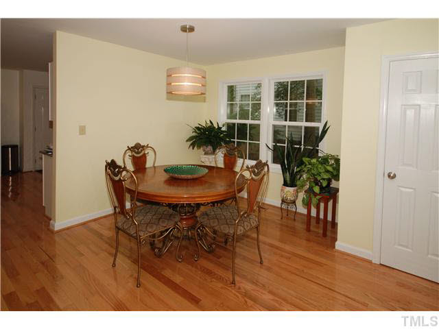 1072 Mills Street Raleigh, NC 27608 - Photo 7 of 25 a view of a dining room with furniture and wooden floor