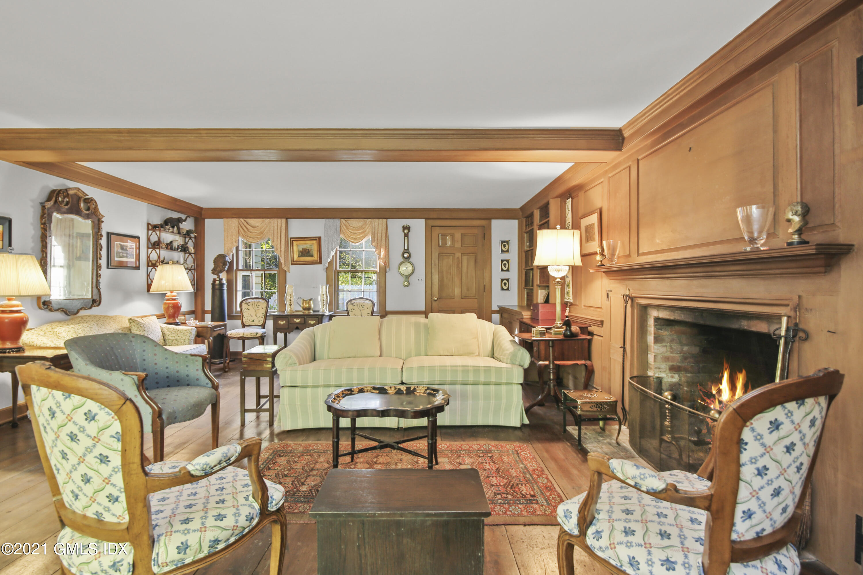 117 Dingletown Road Greenwich, CT 06830 - Photo 15 of 25 a living room with furniture a fireplace and a table