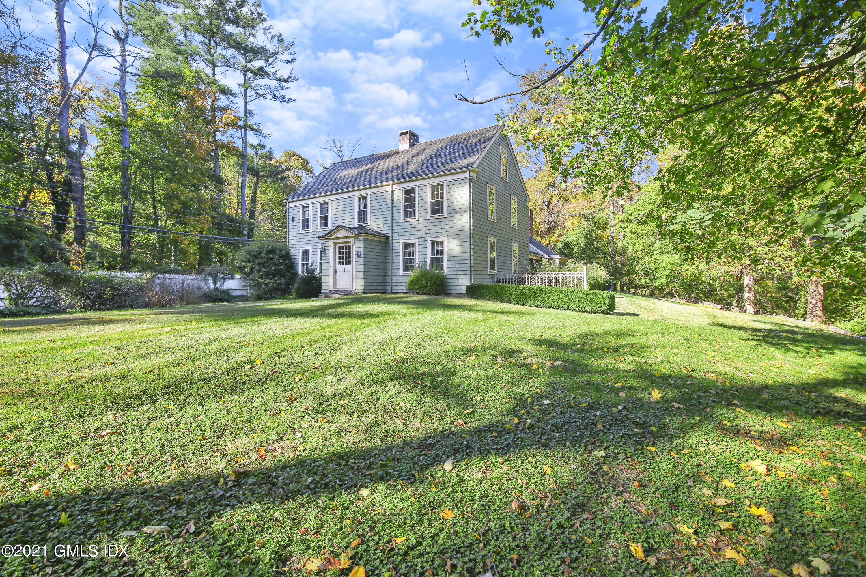 117 Dingletown Road Greenwich, CT 06830 - Photo 17 of 25 a view of a house with a big yard and large trees