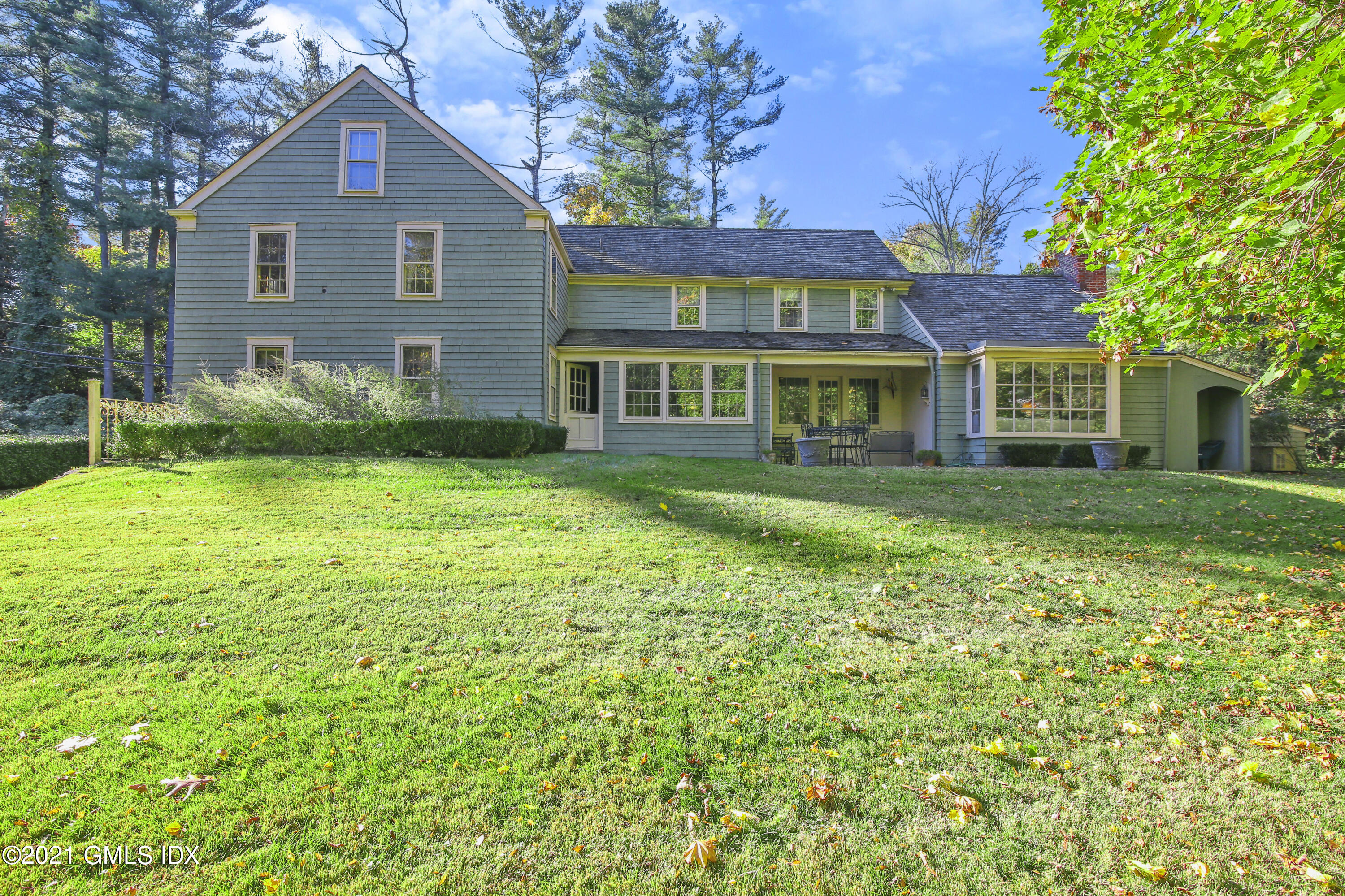 117 Dingletown Road Greenwich, CT 06830 - Photo 19 of 25 a front view of a house with a garden
