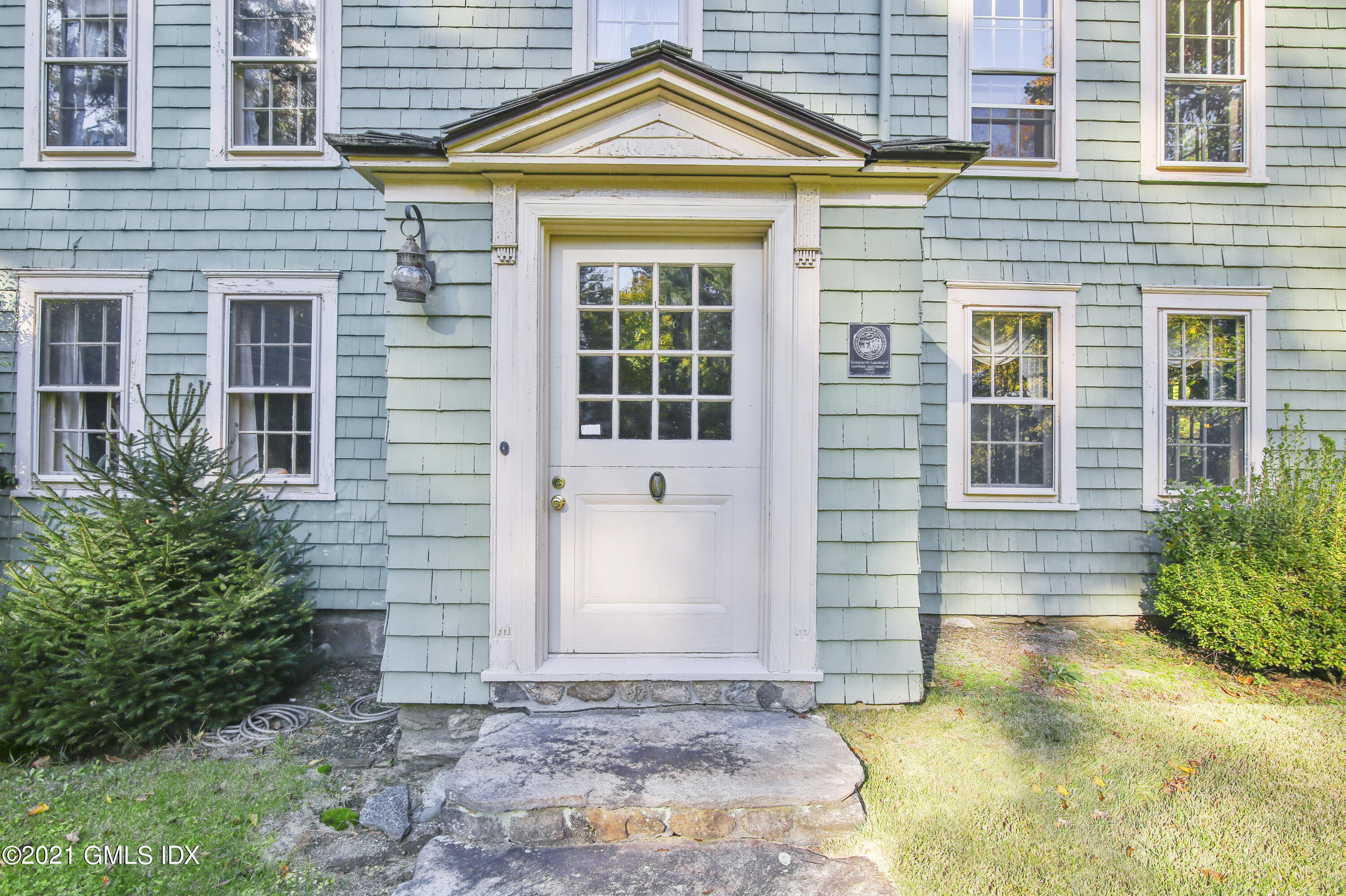 117 Dingletown Road Greenwich, CT 06830 - Photo 2 of 25 a front view of a house with a yard