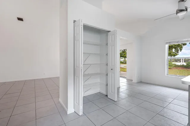 a view of an empty room and closet area