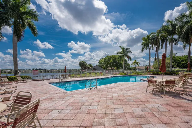 a view of swimming pool with outdoor seating and plants
