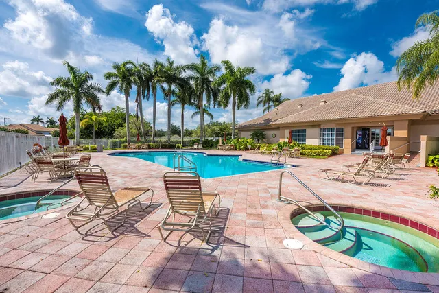 a view of a swimming pool with lounge chairs