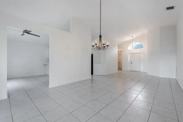a view of a chandelier fan and entryway