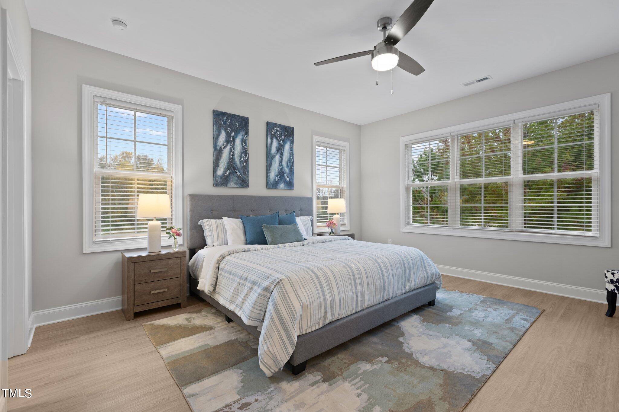 603 Marshskip Way Rolesville, NC 27571 - Photo 16 of 30 a bedroom with a large bed and a window