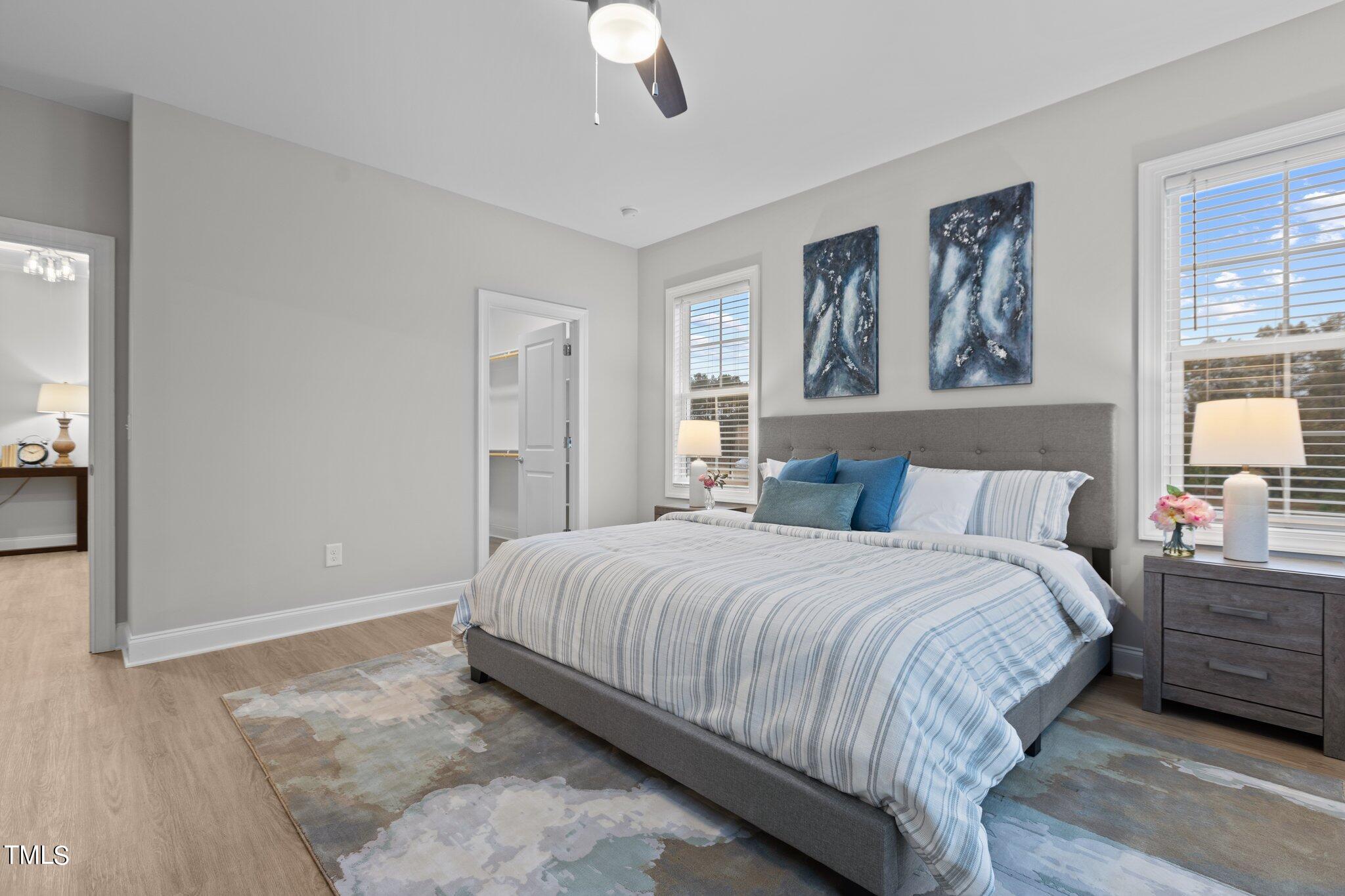 603 Marshskip Way Rolesville, NC 27571 - Photo 17 of 30 a bedroom with a large bed and a chandelier