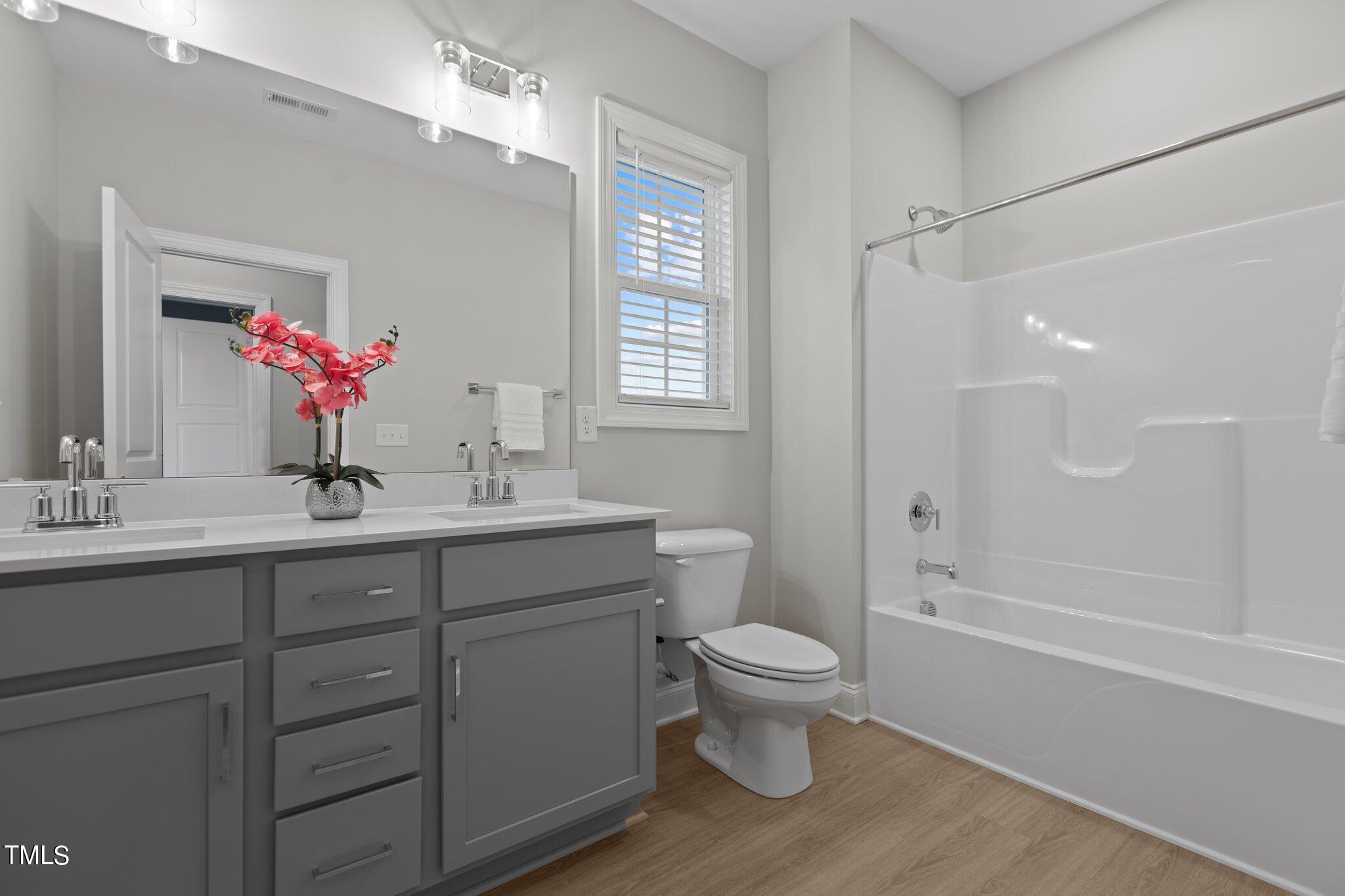 603 Marshskip Way Rolesville, NC 27571 - Photo 21 of 30 a bathroom with a sink a toilet and shower