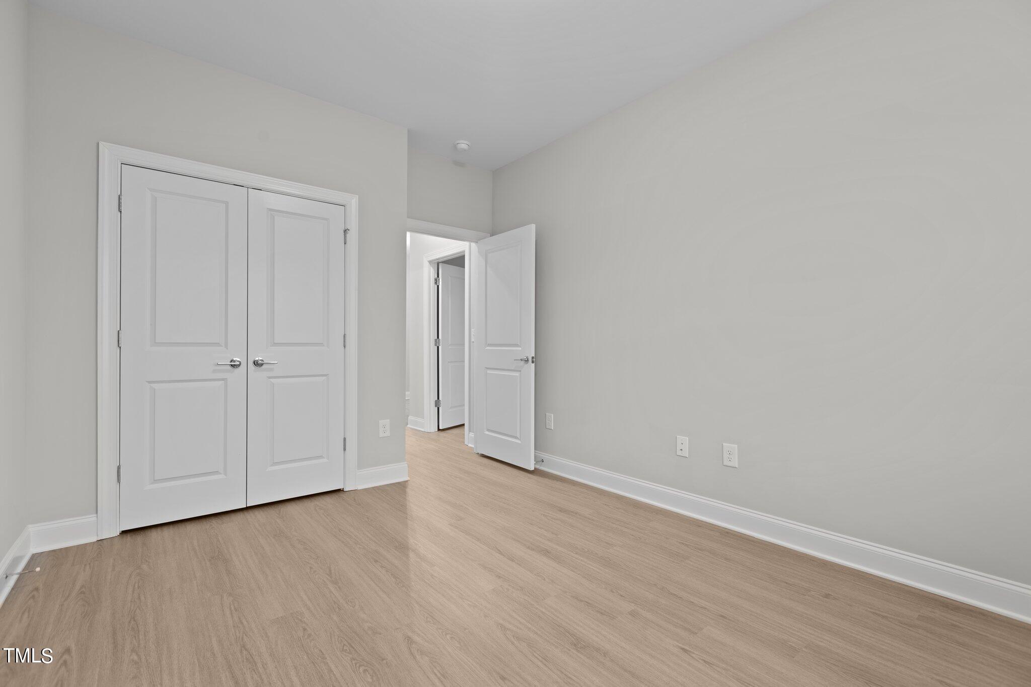 603 Marshskip Way Rolesville, NC 27571 - Photo 23 of 30 a view of an empty room and wooden floor