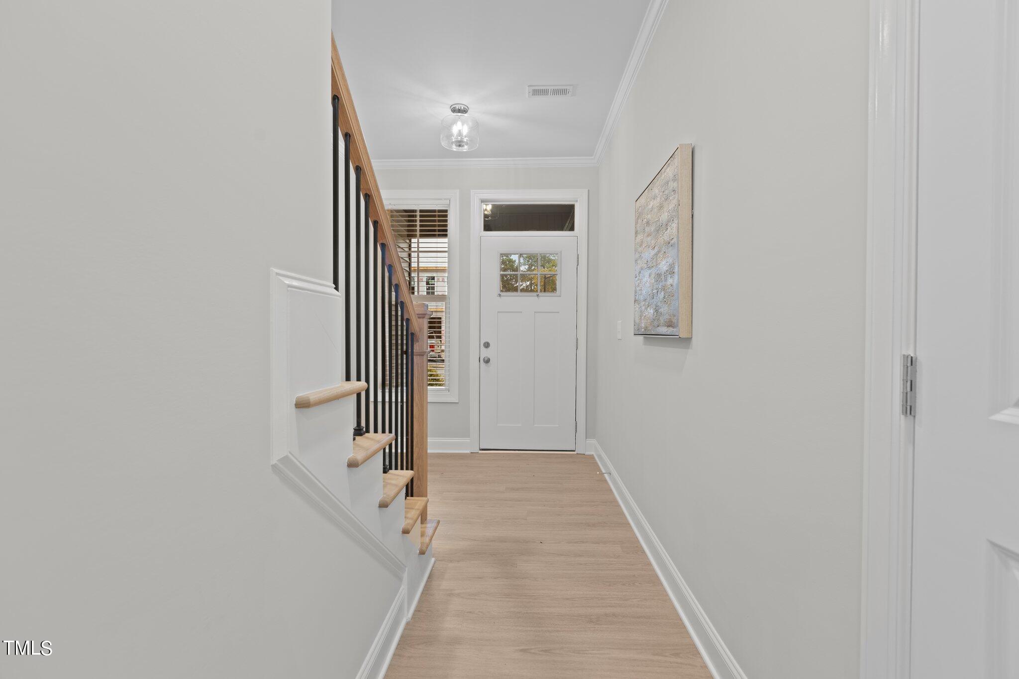 603 Marshskip Way Rolesville, NC 27571 - Photo 3 of 30 a view of a hallway with wooden floor and a bathroom