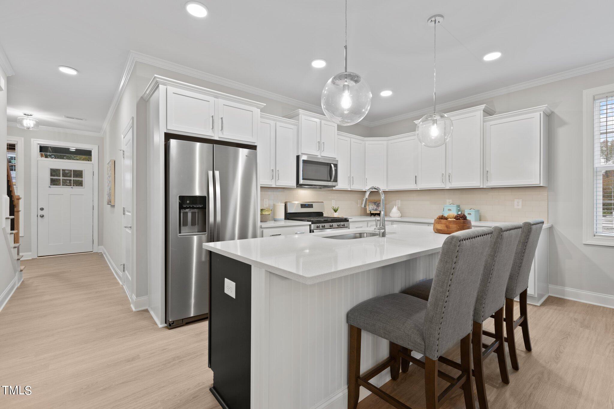 603 Marshskip Way Rolesville, NC 27571 - Photo 6 of 30 a kitchen with a sink stainless steel appliances and chairs
