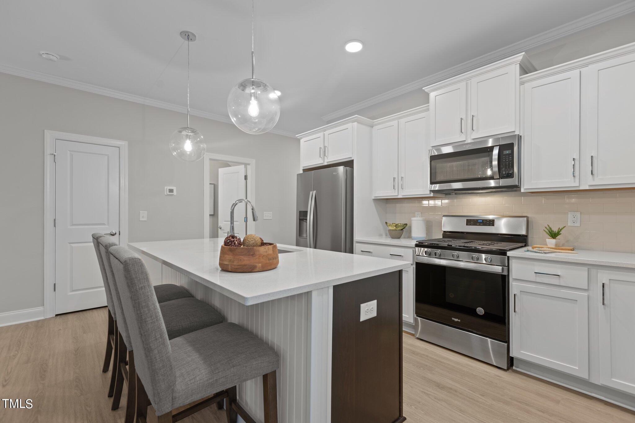 603 Marshskip Way Rolesville, NC 27571 - Photo 7 of 30 a kitchen with a dining table and chairs