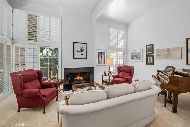a living room with furniture a fireplace and windows