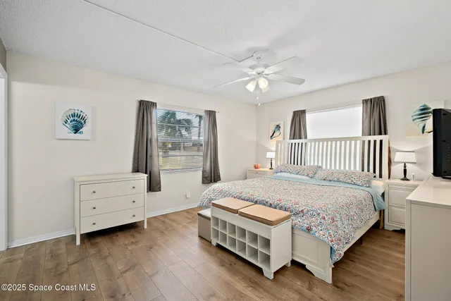 a spacious bedroom with a bed and a dresser
