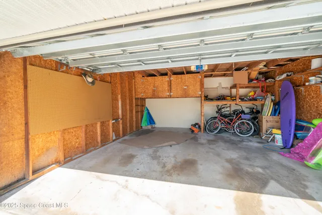 a view of a garage with rack and bicycle