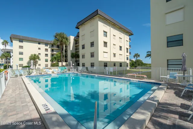 a view of a swimming pool with a lounge chairs