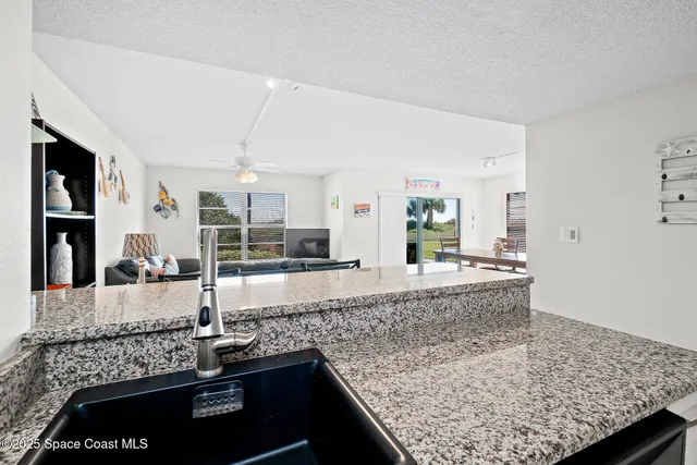 a large kitchen with kitchen island stainless steel appliances a sink stove and cabinets