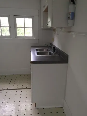 a close view of a sink a stove and dishwasher in a kitchen