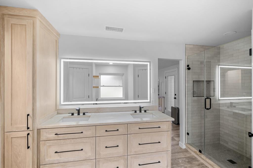 9346 Homestead Lane Forney, TX 75126 - Photo 16 of 39 Beautiful lighted mirrors and white oak cabinetry add that extra touch.