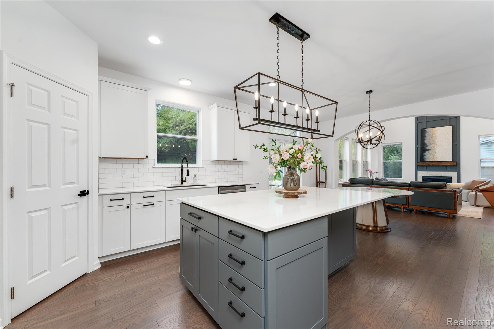 908 South Livernois Road Rochester, MI 48309 - Photo 49 of 49 Kitchen with two tone color scheme, a center island, open floor plan, dark wood-style floors, and tasteful backsplash