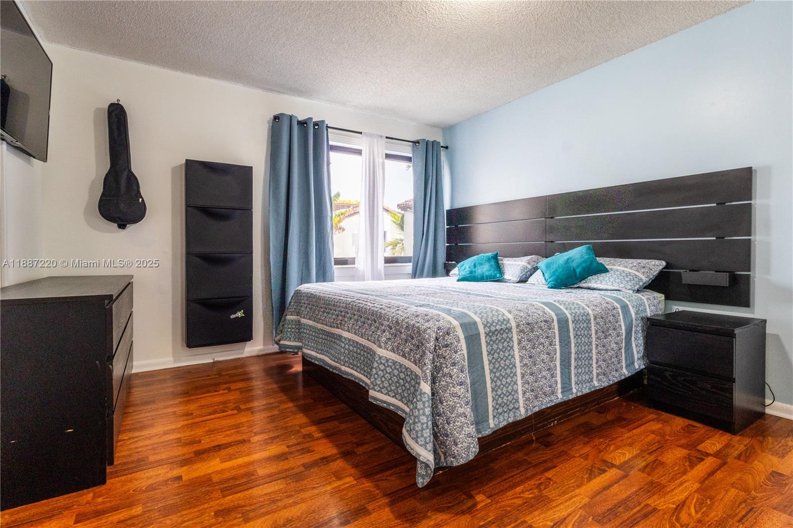 15365 Southwest 104th Terrace, Unit 2 Miami, FL 33196 - Photo 17 of 34 a bedroom with a bed and a fireplace