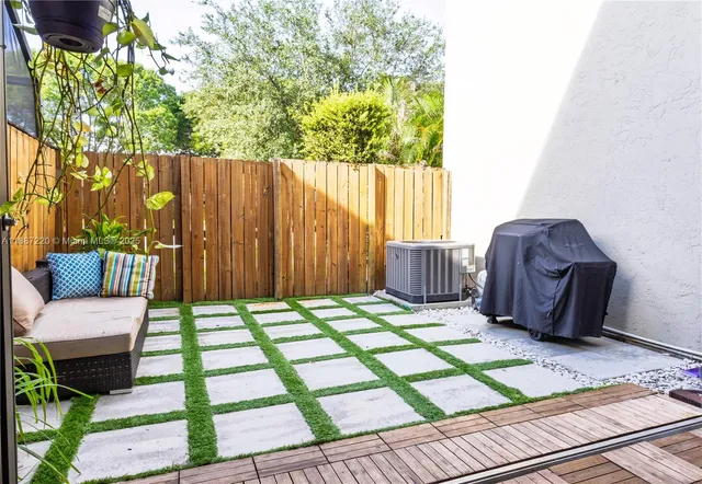 a chair and table sitting in front of a house