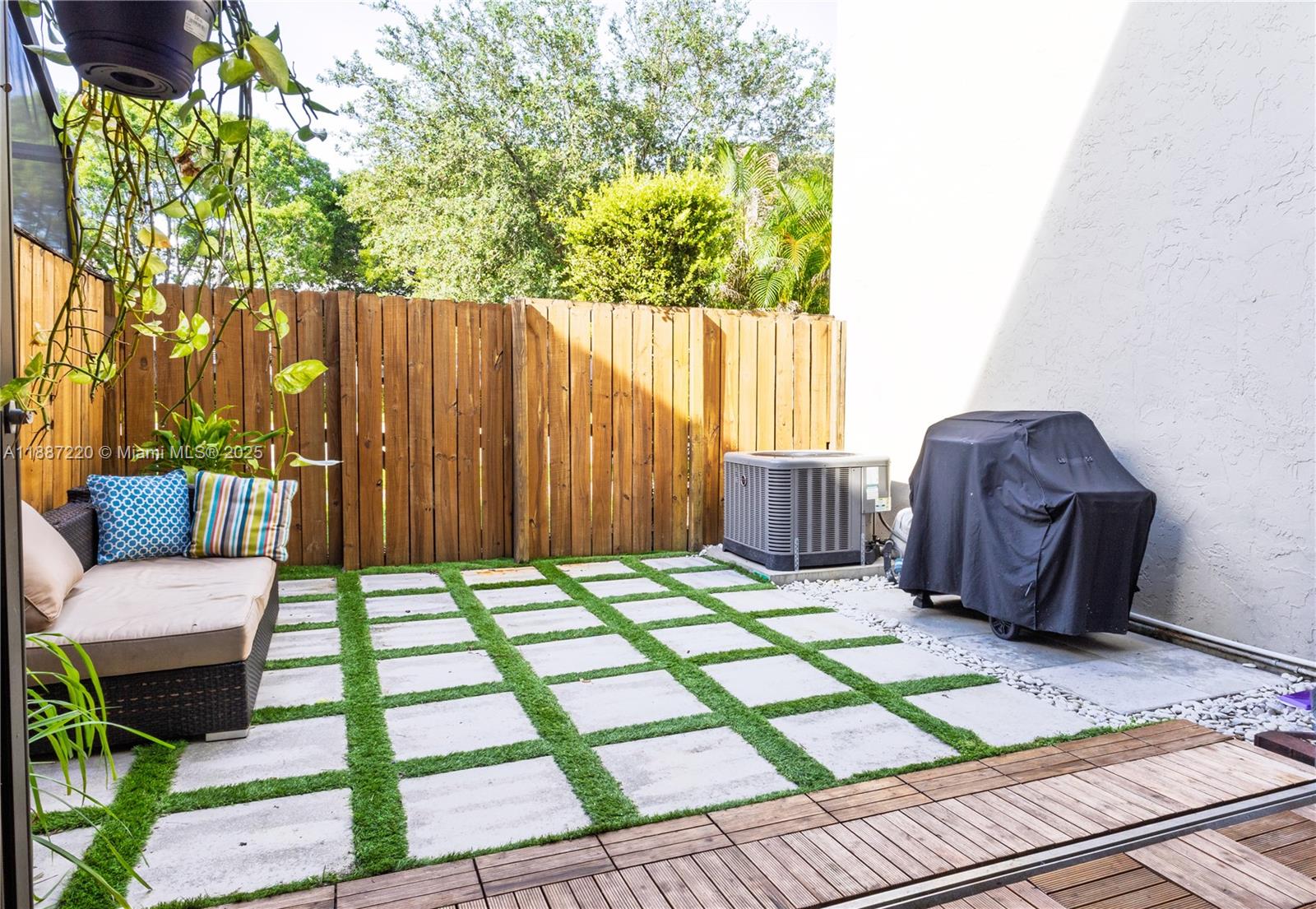 15365 Southwest 104th Terrace, Unit 2 Miami, FL 33196 - Photo 21 of 34 a chair and table sitting in front of a house
