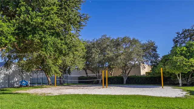 a view of house with a backyard