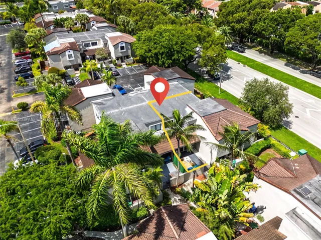 an aerial view of a house with a yard and garden