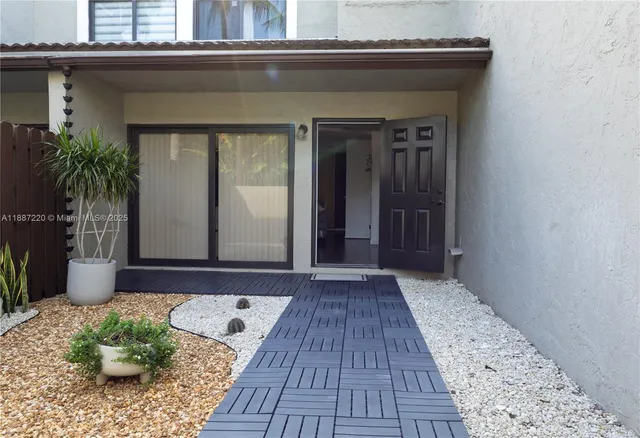 front view of a house with a potted plant