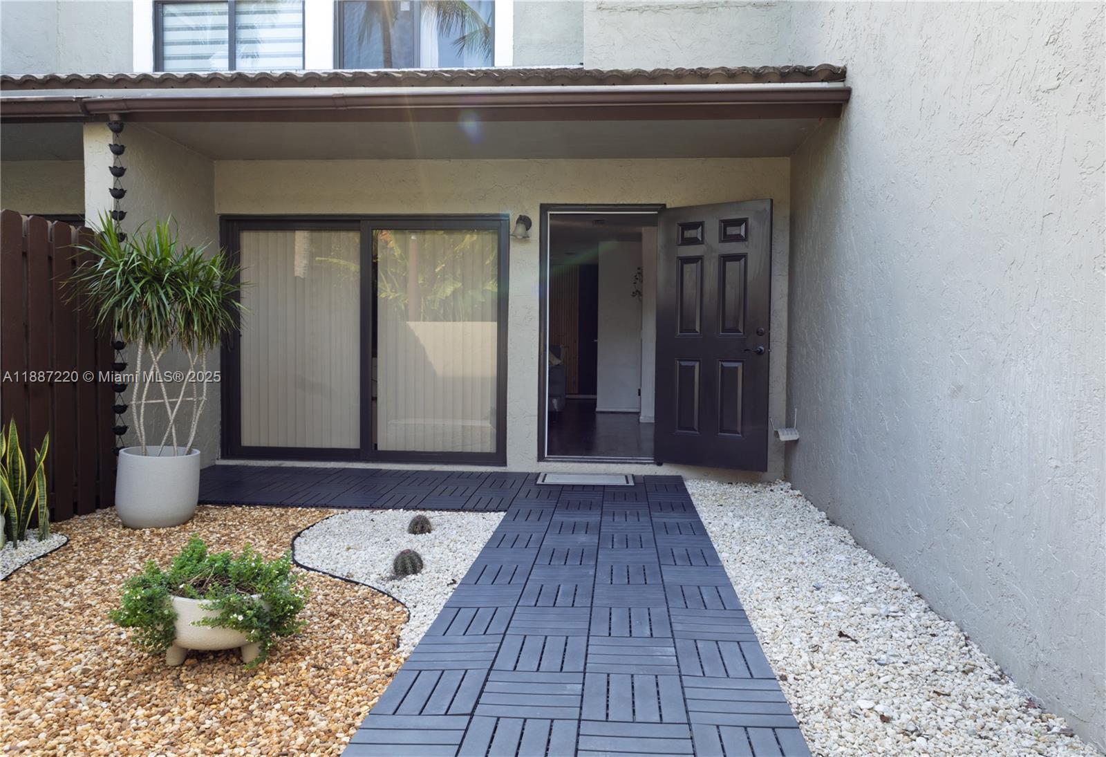 15365 Southwest 104th Terrace, Unit 2 Miami, FL 33196 - Photo 6 of 34 front view of a house with a potted plant