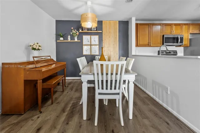 a view of a dining room with furniture and a window