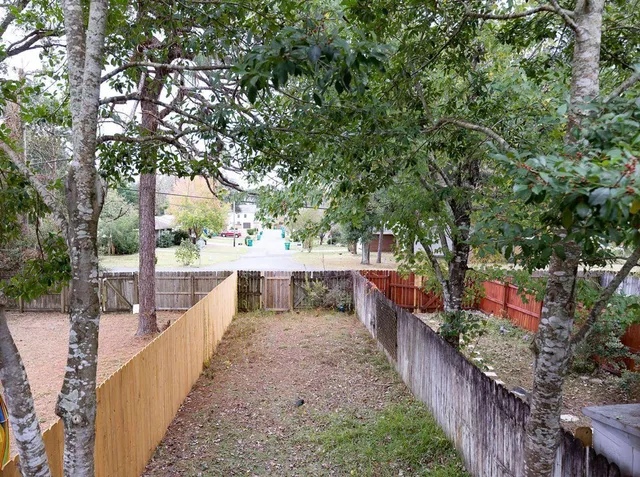 a view of a house with large trees
