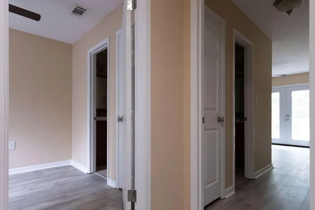 a view of hallway with wooden floor
