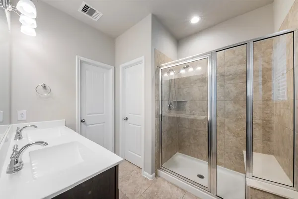 a bathroom with a sink a mirror and a shower