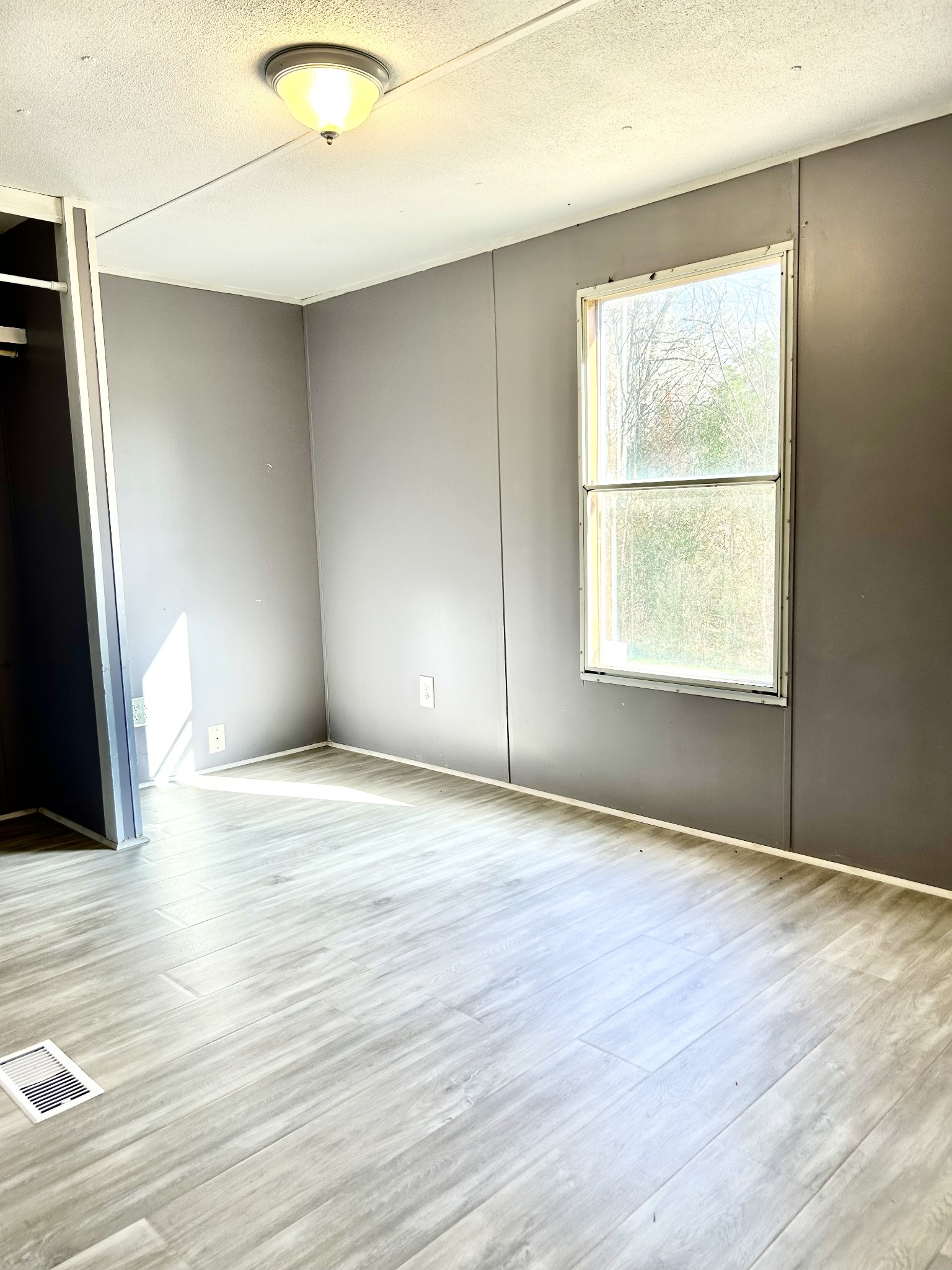 6206 Beech Hill Road Pulaski, TN 38478 - Photo 4 of 8 a view of an empty room with wooden floor and a window
