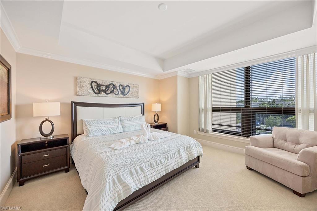 9115 Strada Place, Unit 5213 Naples, FL 34108 - Photo 15 of 32 a bedroom with a bed and a couch