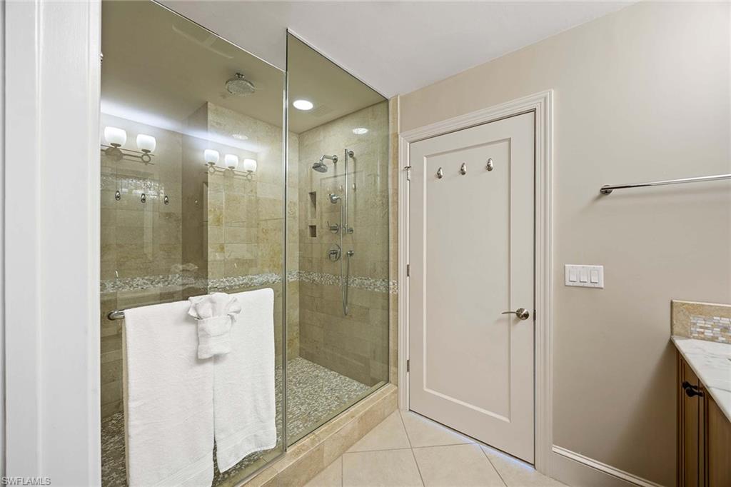 9115 Strada Place, Unit 5213 Naples, FL 34108 - Photo 18 of 32 a bathroom with a shower and a sink