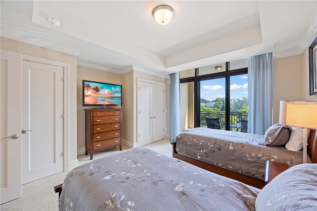 9115 Strada Place, Unit 5213 Naples, FL 34108 - Photo 20 of 32 a bedroom with a bed and a couch