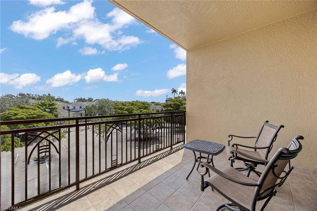 9115 Strada Place, Unit 5213 Naples, FL 34108 - Photo 24 of 32 a view of a balcony with wooden floor and outdoor space