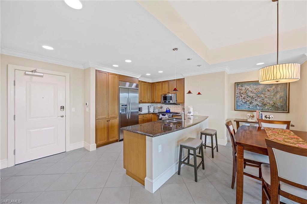 9115 Strada Place, Unit 5213 Naples, FL 34108 - Photo 4 of 32 a view of a kitchen and dining room